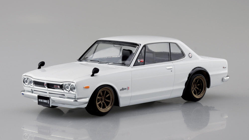 Aoshima snap fit Model of a white Nissan Skyline 2000 GTR on a grey background