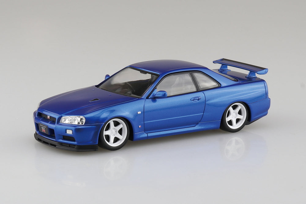 Aoshima snap fit Blue model Nissan R34 Skyline GTR car on a gray background