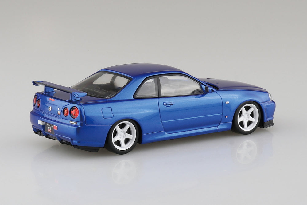 Blue Nissan R34 Skyline model car on a gray background