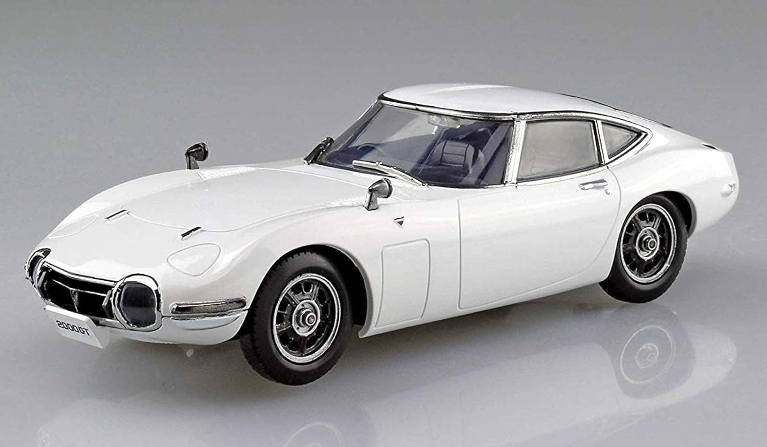 White Toyota 2000GT model car on a gray background