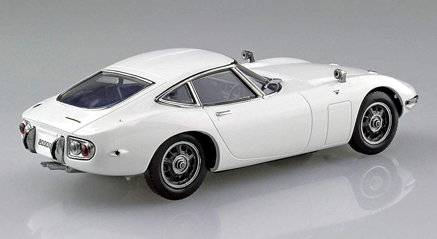 White Aoshima Toyota 2000GT sports car model on a gray background