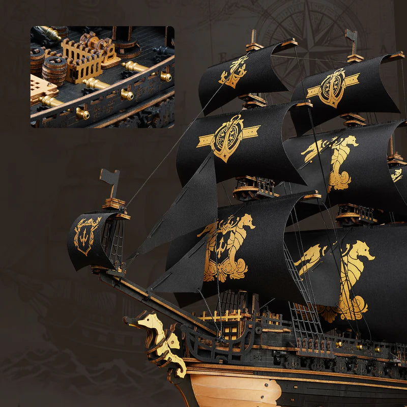 Model of a black sailing ship with gold details on a dark background