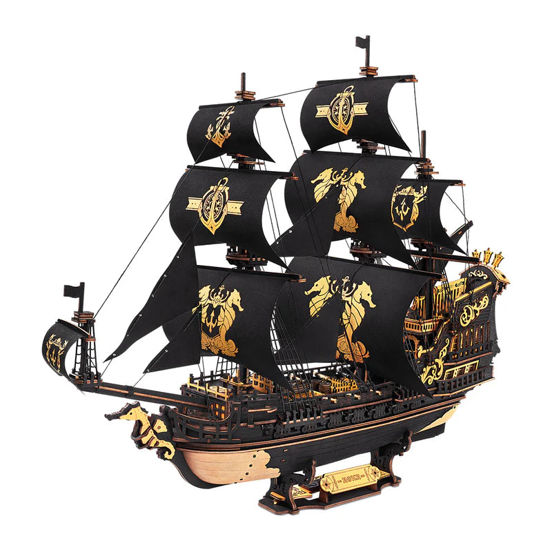 Model ship with black sails and gold details on a white background