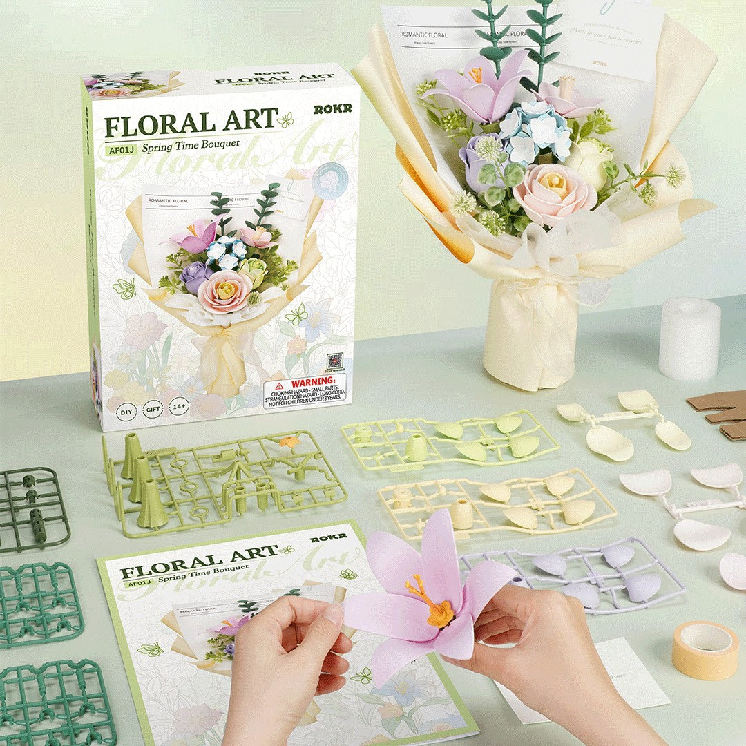 Floral art kit with packaging, materials, and a completed bouquet on a table.