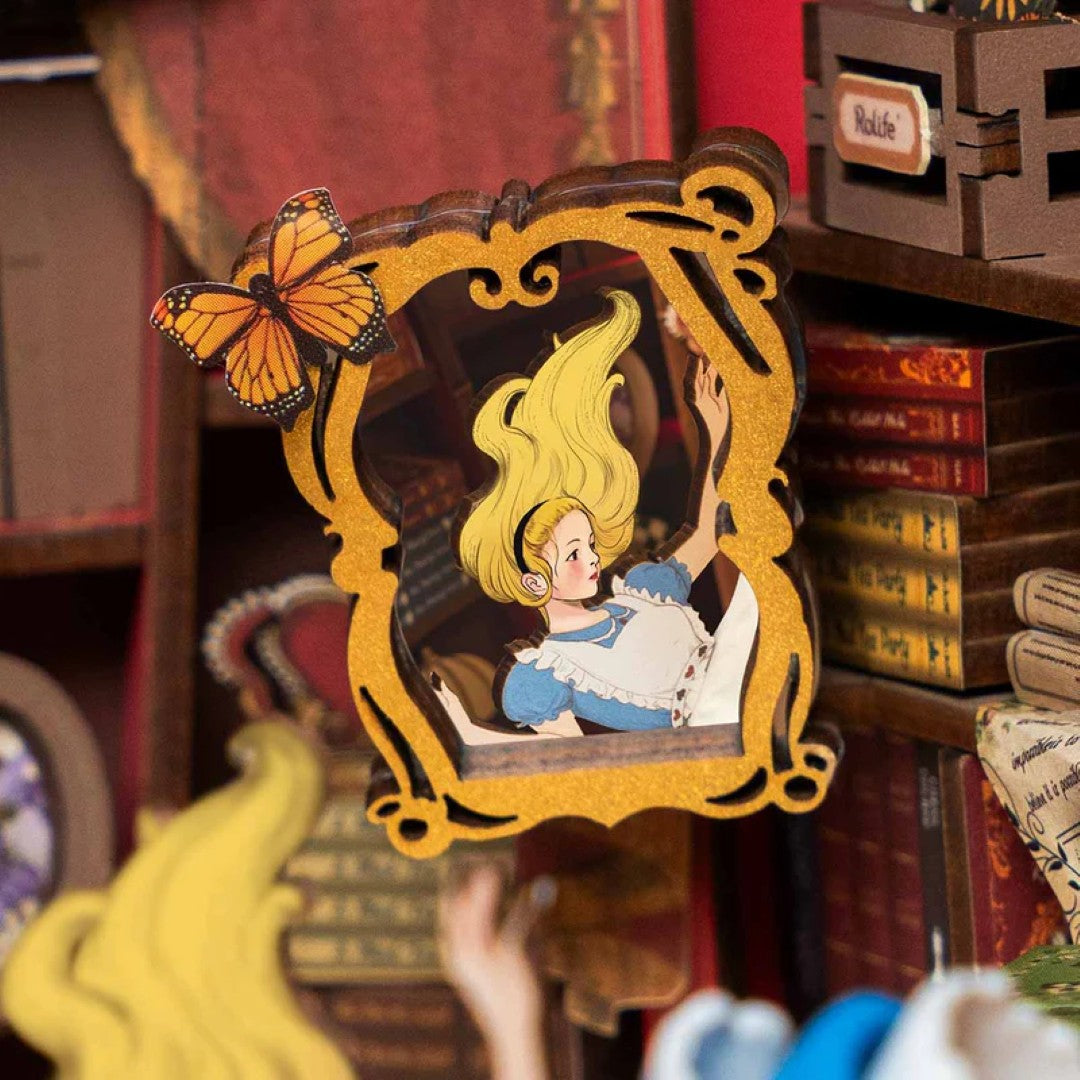 Decorative mirror with a framed illustration of a woman with yellow hair and a butterfly, set against a bookshelf background.