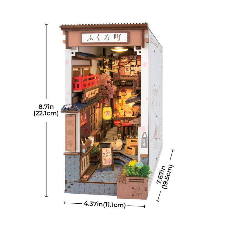 Model of a small town street with dimensions indicated on a white background