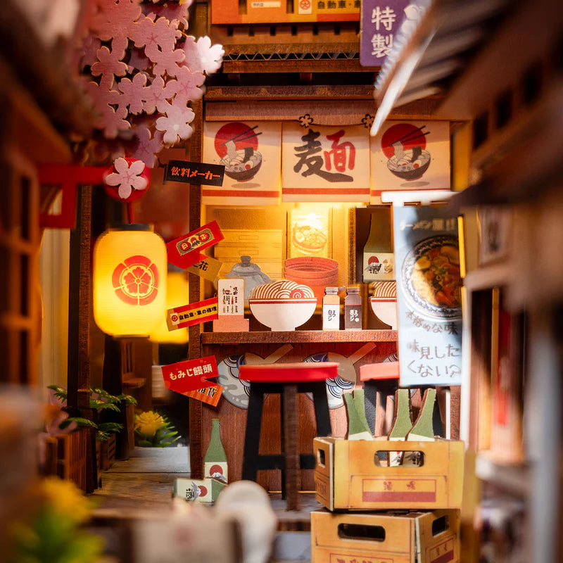 Miniature model of a Japanese restaurant interior with various items and decorations.