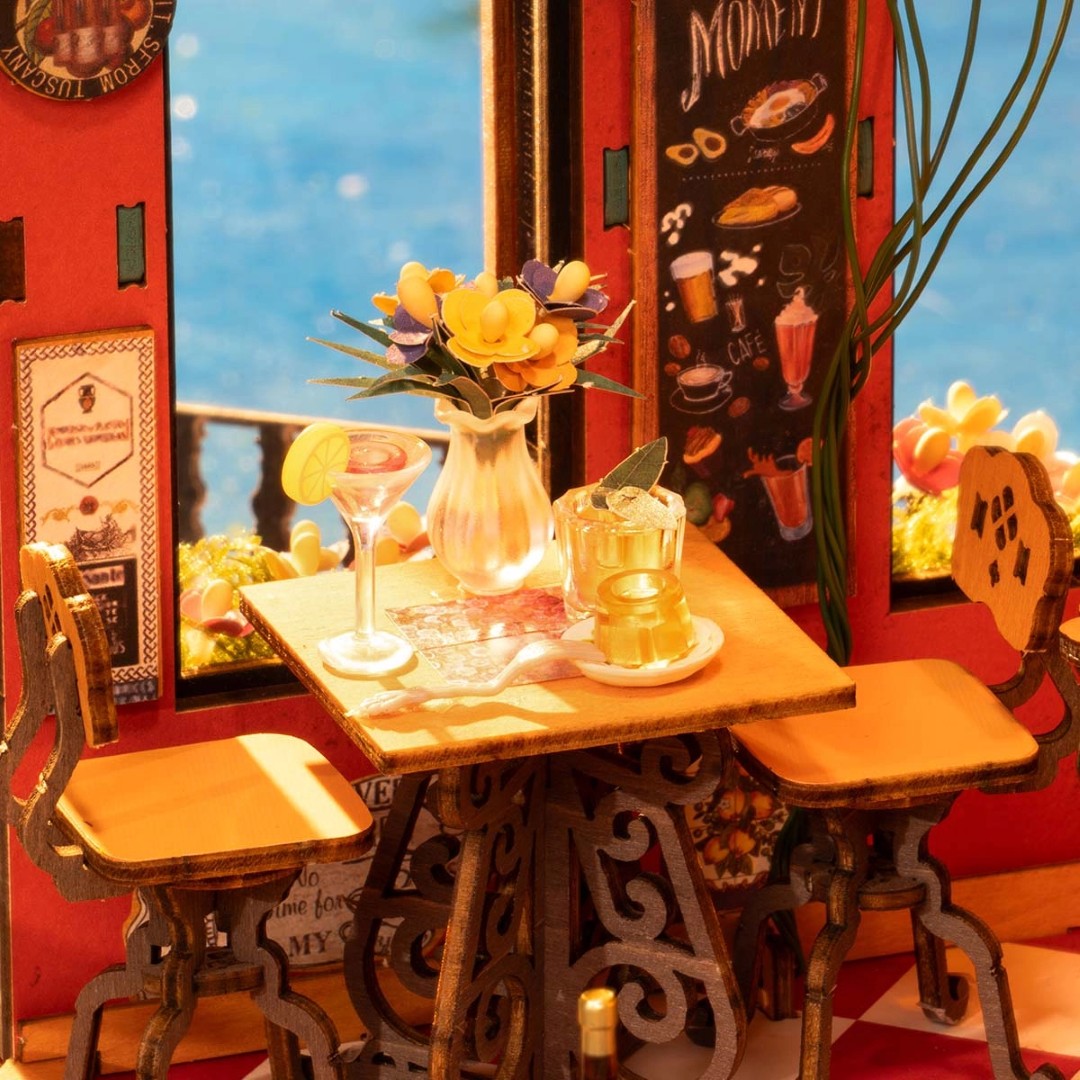 Miniature table setting with flowers and drinks in a colorful room.