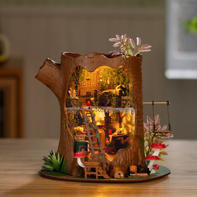 Wooden fairy house with interior lights on a wooden surface
