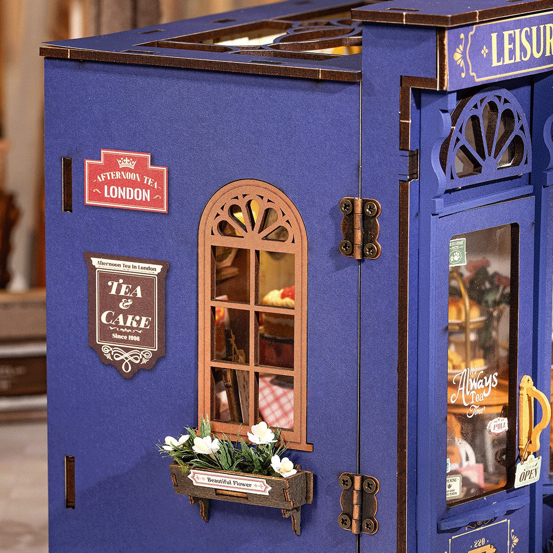 Blue toy tea house with detailed interior and decorative elements.