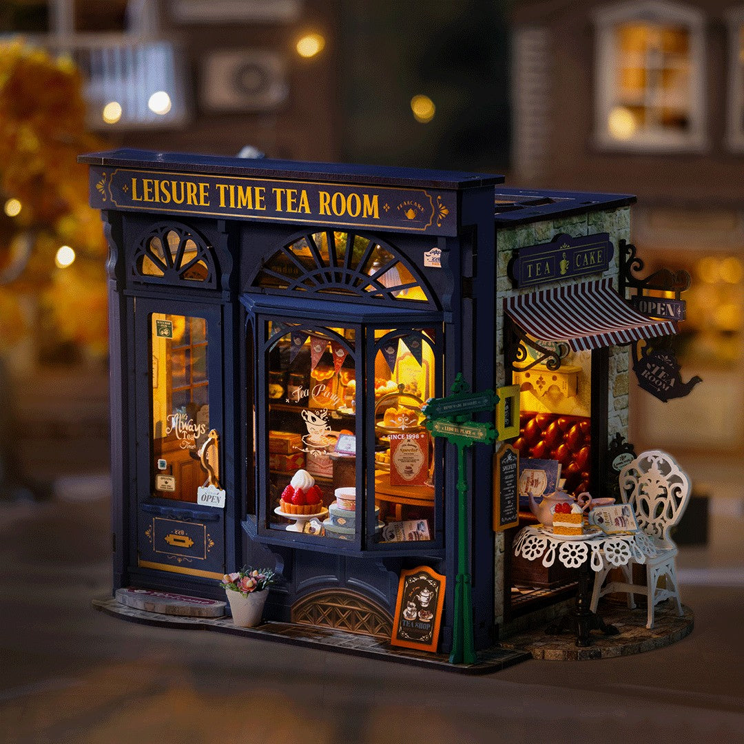 Model of a tea room with 'Leisure Time Tea Room' sign, illuminated interior, and decorative elements.