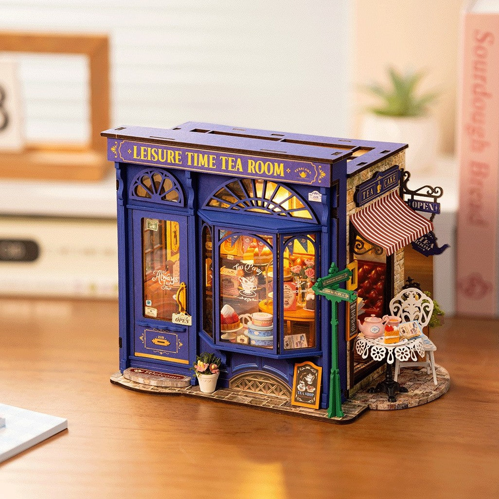 Model of a tea room with 'Leisure Time Tea Room' sign on a wooden surface.
