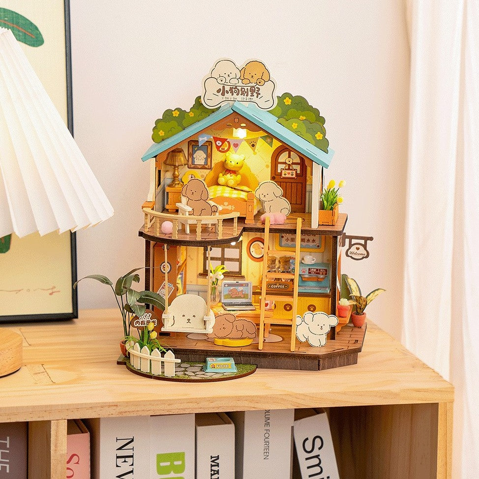 Wooden dollhouse with LED lights on a desk