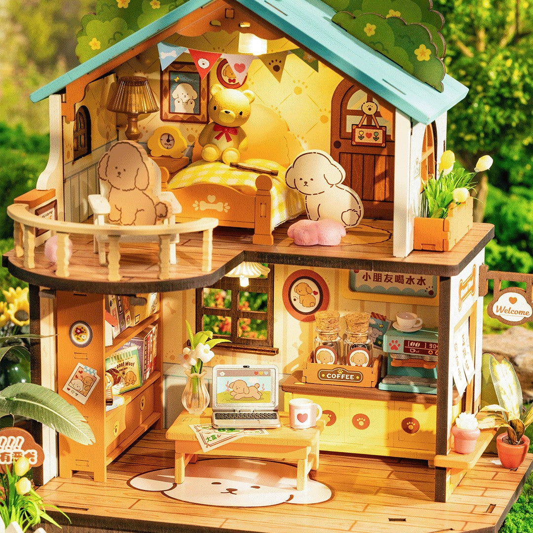 Detailed wooden dollhouse with furniture and decor, surrounded by greenery.