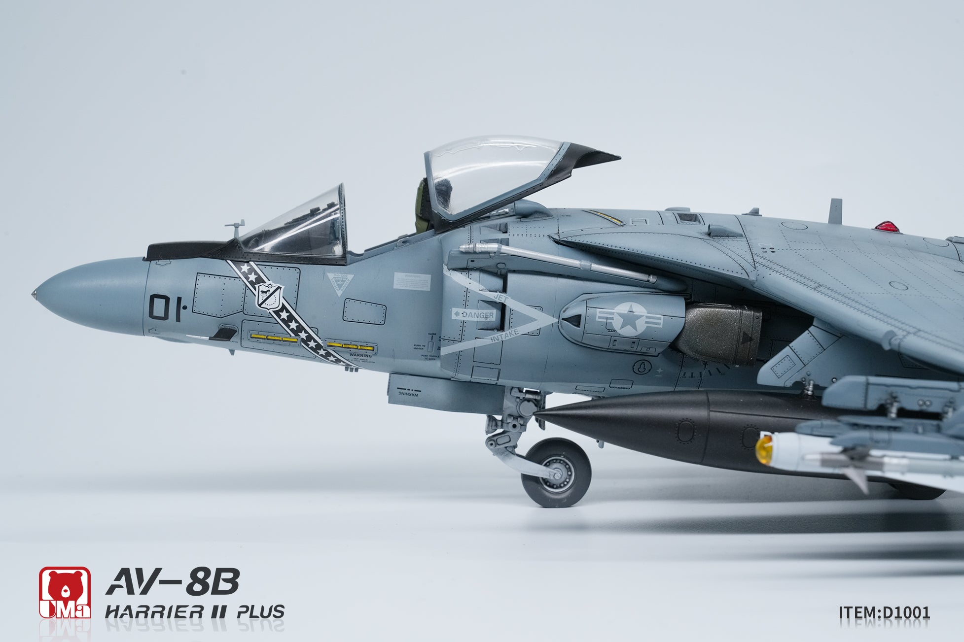 Model of an AV-8B Harrier II Plus aircraft on a light gray background