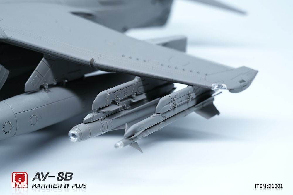Model of an AV-8B Harrier II Plus aircraft with missiles on a white background