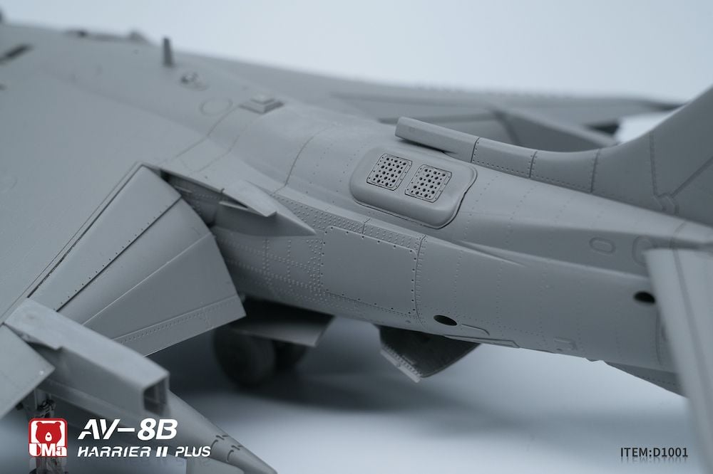 Close-up of a model AV-8B Harrier II Plus on a gray background