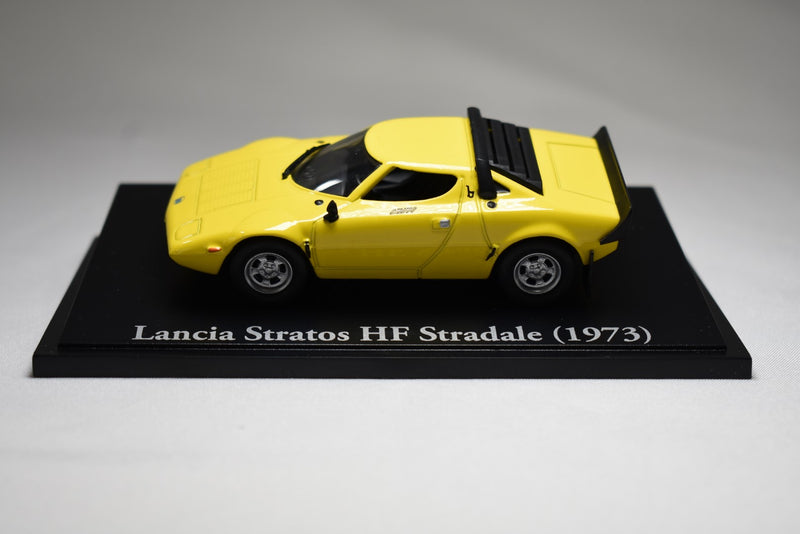 Atlas Editions Lancia Stratos HF Stradale 1973 yellow 1:43 scale diecast model on display stand