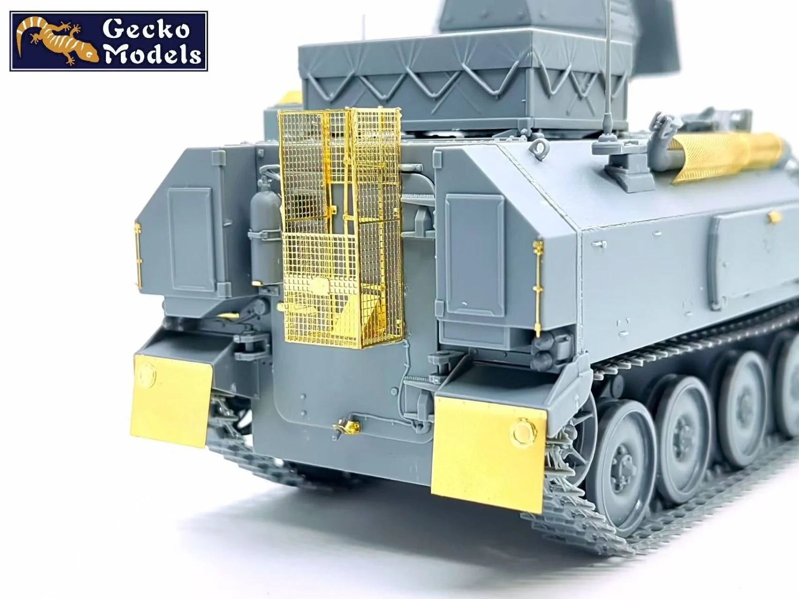 Model of a military vehicle with yellow accents on a white background, branded 'Gecko Models'.