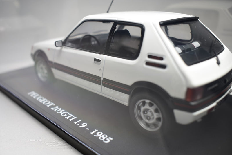 Peugeot 205 GTI 1.9 1985 1:24 scale diecast model on stand with display case side