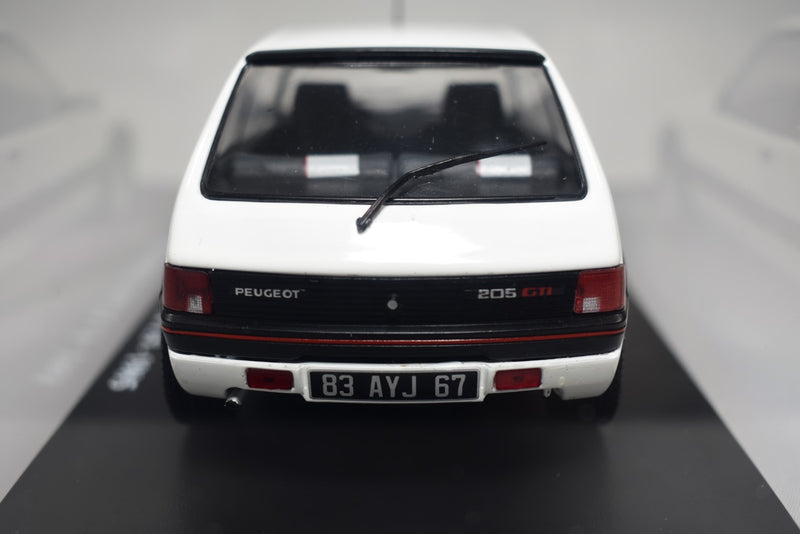 Peugeot 205 GTI 1.9 1985 1:24 scale diecast model on stand with display case raer