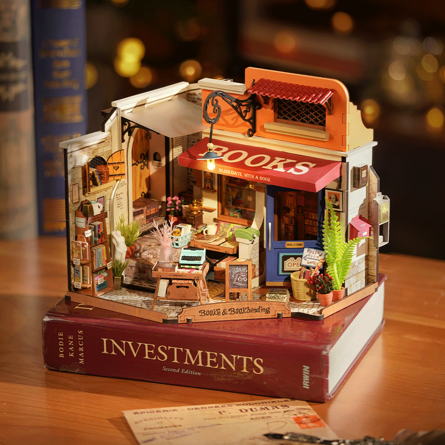 Rolife Corner Bookstore DIY Minature House Model Kit built sitting on books