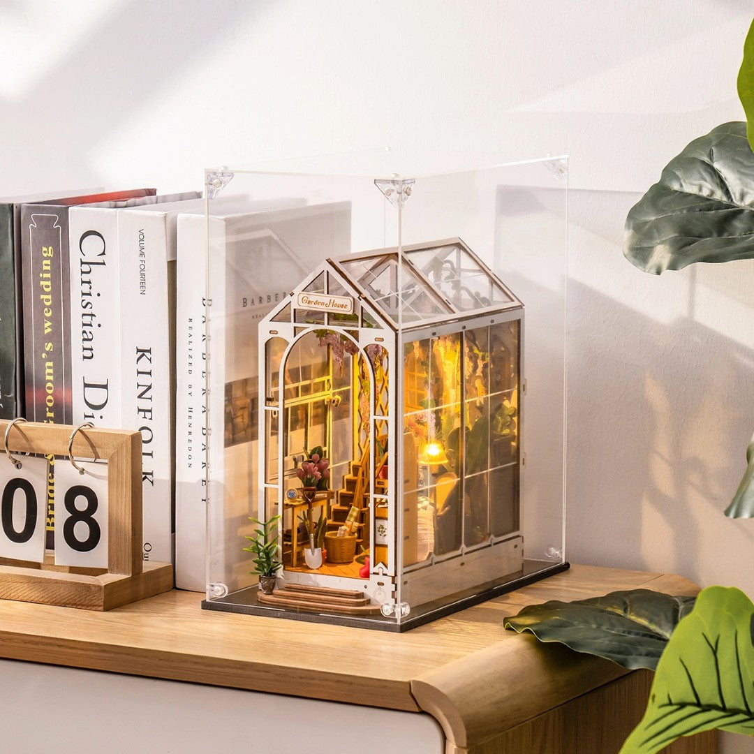 rolife book nook display case on a wooden surface with books and a calendar in the background.