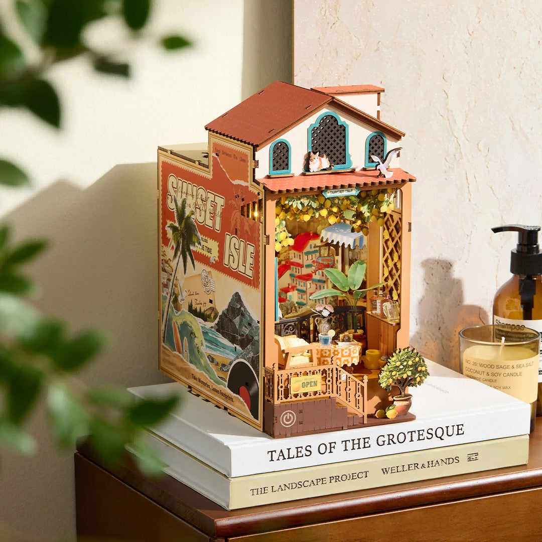 Miniature house model on top of a book with decorative elements